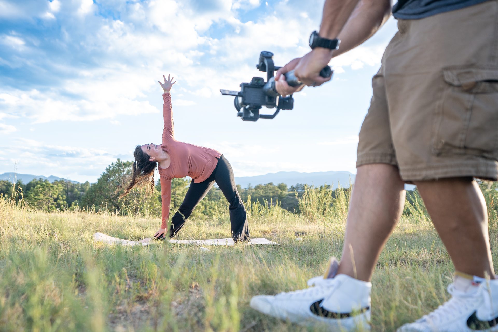 Gethen Christine practising yoga in a field while being filmed